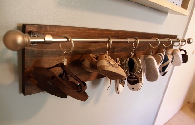 Hang baby shoes on a curtain rod.