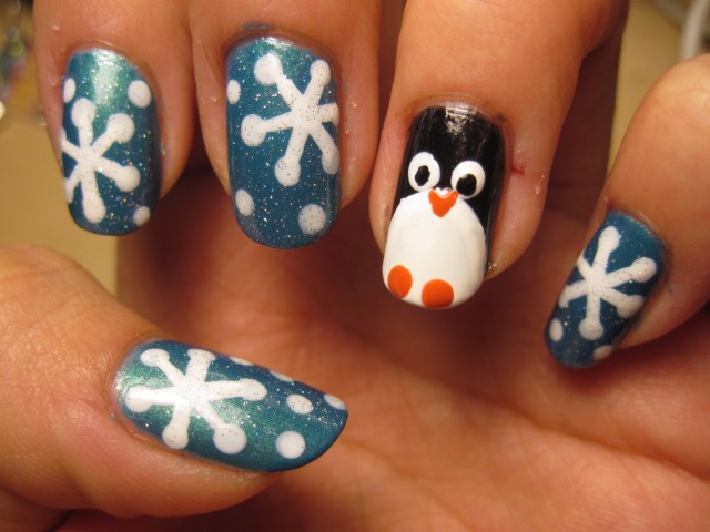 general-simple-white-snowflake-nail-art-design-on-blue-glitter-nails-idea-with-cute-penguin-nail-accent-snowflake-nail-art